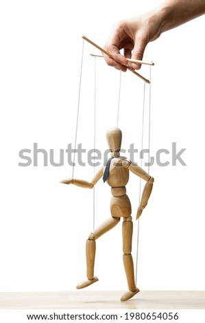 The human hand with marionette on the strings. Concept of control. On white.