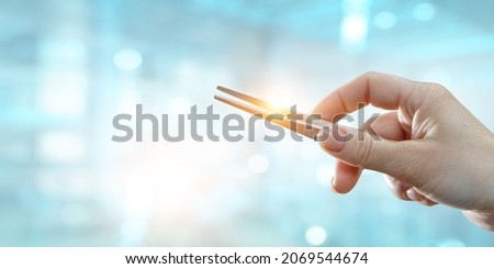 Human hand with metal pincers