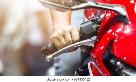 Human Hand In A Motorcycle Racing Holds A Motorcycle Throttle Control