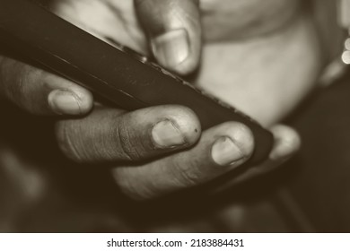 A Human Hand Operating A Old Versioned Modern Keypad System Mobile Phone. Closeup Or High Magnification View. Copy Space. 