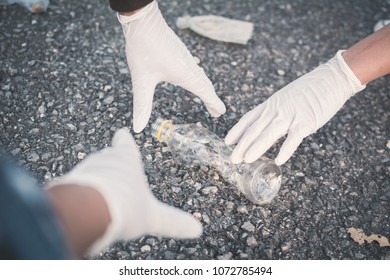 Human Hand Picking Up Empty Bottle Plastic On Park ,volunteer Concept