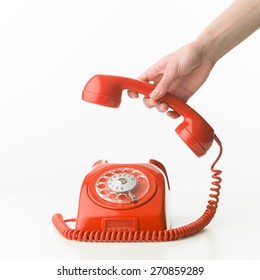 Human Hand Picking Up The Phone, On White Background