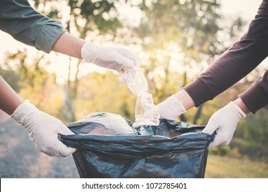 Human Hand Picking Up Plastic Into Bin Bag On Park ,volunteer Concept