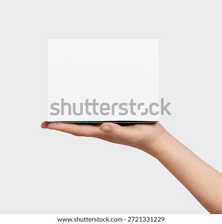 Human hand presenting a generic plain white unbranded square box, ready for custom branding or showcasing a new product, gift, or delivery concept against a clean light background