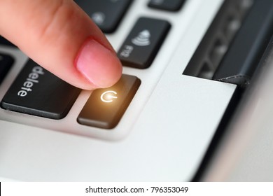 human hand press shutdown button on computer keyboard
