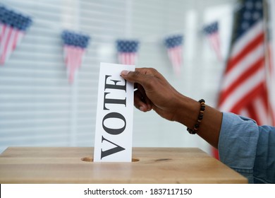 Human Hand Putting In Voting Card Into Ballot Box