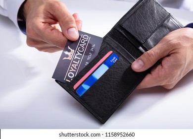 Human Hand Removing Loyalty Card From Wallet On White Background