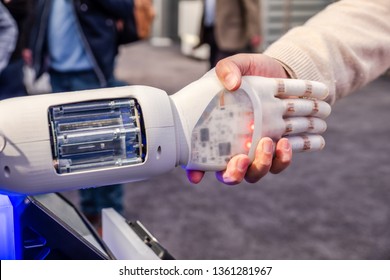 Human hand and robot's as a symbol of connection between people and artificial intelligence technology.