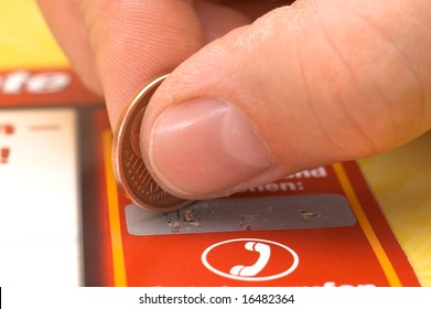 A Human Hand Is Scratching A Lottery Ticket