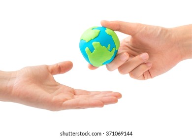 Human hand sending the earth into another hand isolated on white background. environment, Creation, Genesis, God and Adam, Responsibility, Mission concept. Earth day holiday concept - Shutterstock ID 371069144