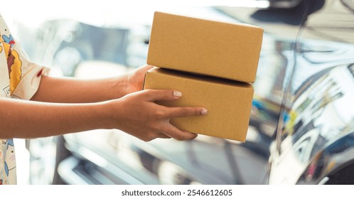 Human hand sending a parcel box,Woman sending packages, moving, unpacking. Woman holding cardboard box. Woman who is not recognized as holding a box. - Powered by Shutterstock