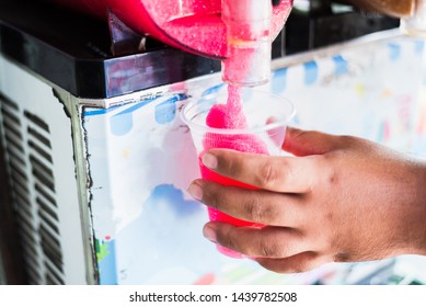 Human Hand Serving Slushy Drink From Slushy  Machine