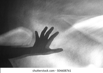 Human Hand Shadow On Vintage Wall Background