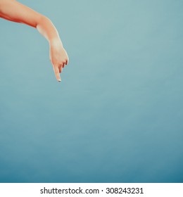 Human hand showing blank empty copyspace on blue. Advertisement.