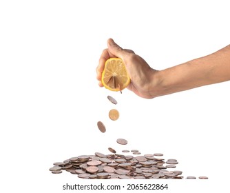 Human hand squeezing a lemon from which coins come out. Coins falling into heap of money, isolated on a white background