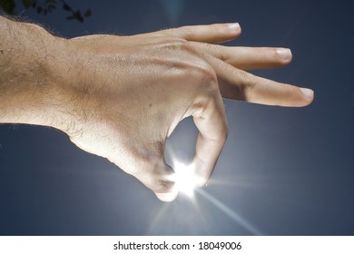 human hand, sun and blue sky