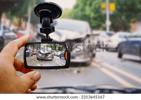 The human hand is touching camera on the car for check image car accident