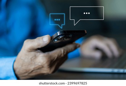 Human hand using smartphone typing Live chat chatting and social network concepts, chatting conversation working at home in chat box icons pop up. Social media marketing technology concept	