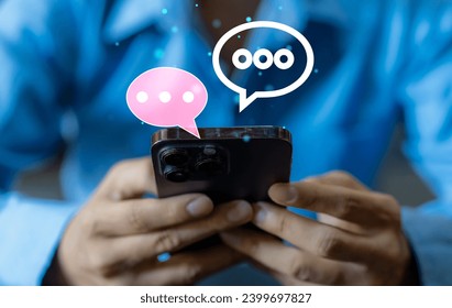 Human hand using smartphone typing Live chat chatting and social network concepts, chatting conversation working at home in chat box icons pop up. Social media marketing technology concept	