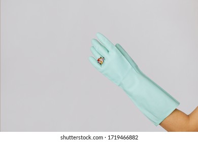 Human Hand Is Wearing A Medical Glove, Glove, Isolated. Woman's Hands With A Ring In Rubber Gloves