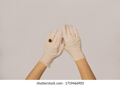 Human Hand Is Wearing A Medical Glove, Glove, Isolated. Woman's Hands With A Ring In Rubber Gloves