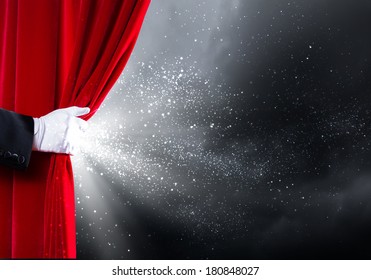 Human Hand In White Glove Opening Red Velvet Curtain