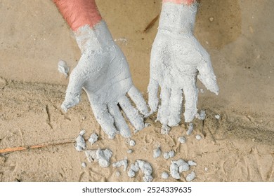 Human hands with clay. Mud baths with blue clay. Unique blue clay from the bottom of Lake Svityaz, Volyn, Ukraine.