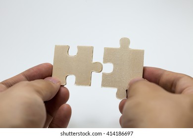 Human hands connecting pieces of jigsaw - Business team, solving problem together concept - Shutterstock ID 414186697