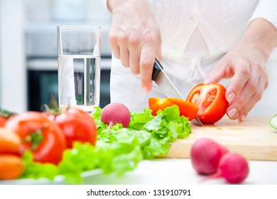 Human Hands Cooking Vegetables Salad In Kitchen