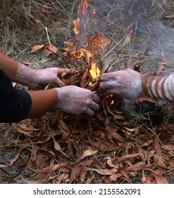 Human hands with fire, the fire ritual rite at a community event in Australia,