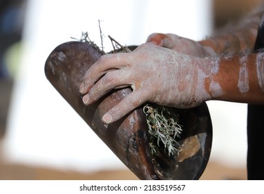 Human Hands With Green Branches Of Eucalyptus And Wood, The Fire Ritual Rite At A Indigenous Community Event In Australia