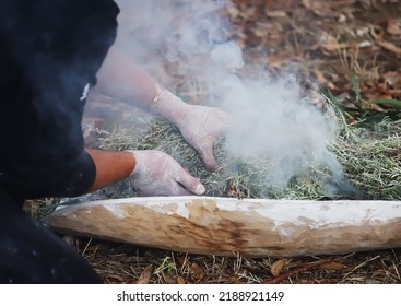 Human Hands With Green Branches Of Eucalyptus, The Fire Ritual Rite At An Indigenous Community Event In Australia