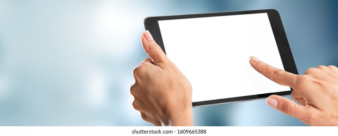 Human hands holding digital tablet with a white blank screen