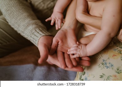 human hands of mom and baby dad