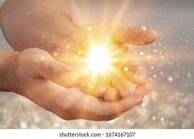 Human hands praying for blessing with lights shining - Shutterstock ID 1674167107