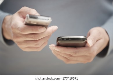 Human Hands Using Two Smartphones For Data Transfer