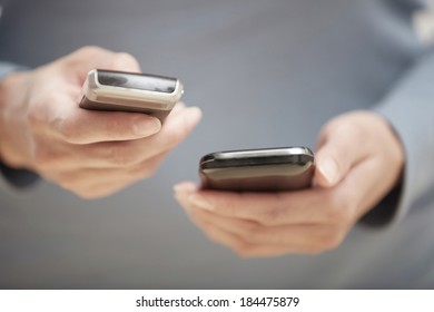 Human hands using two smartphones for data transfer