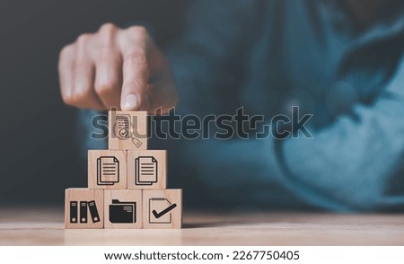Human hands, wooden blocks and icons ,Concept of pre-approval quality assessment ,business accounting documents ,auditor ,management and auditing of office documents ,Reports for Tax Time Analysis