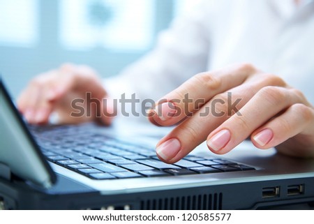 Human hands working on laptop on office background