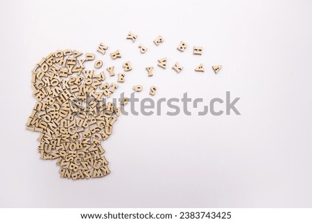 Human head made from wood letters on white background. World philosophy day 17 November..