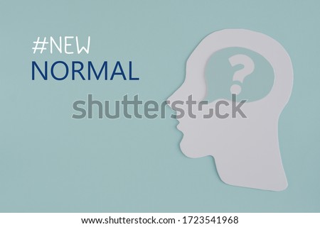 Human head with question mark inside paper cut out and word New Normal, post covid-19 coronavirus pandemic confusion of new normal concept