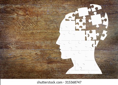 Human head as a set of puzzles on the wooden background - Shutterstock ID 315368747