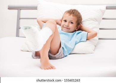 Human Healthcare And Medicine Concept - Little Child Boy With Plaster Bandage On Leg Heel Fracture Or Broken Foot Bone