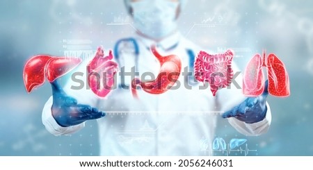 Human internal organs treatment concept. The doctor shows the patient's organs, a hologram with medical indications. Modern medicine, healthcare, medical insurance