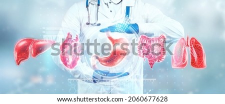 Human internal organs treatment concept. The doctor shows the patient's organs, a hologram with medical indications. Modern medicine, healthcare, medical insurance