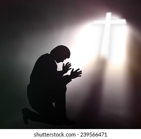 Human kneeling and raising hands over the cross.