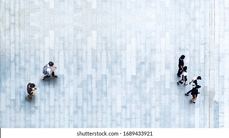 Human Life In Social Distance. Aerial Top View With Blur Man With Smartphone And Group Of People Walking At Pedestrian Crosswalk On Grey Pavement Street Road With Empty Space.