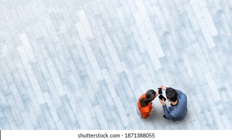 Human Life In Social Distance. Aerial Top View With People With Smartphone And Group Of People Walking At Pedestrian Crosswalk On Grey Pavement Street Road With Empty Space.