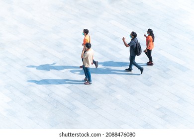 Human life in Social distance. people walk with smartphone on the pedestrian street walkway with the teenage young men. Wide panoramic view of people crossing outdoor space. (Aerial urban city photo) - Powered by Shutterstock