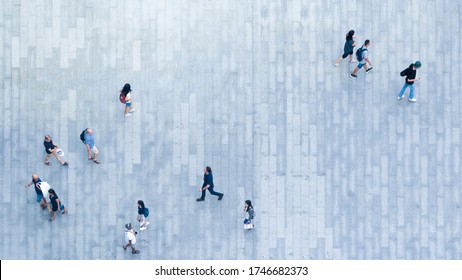 Human Life In Social Distance. Top View Of Motion Blur People Are Walking In Public Space On Concrete Pavement Landscape. Concept In Aerial View Of Man And Woman Family With Empty Space.